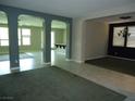 Spacious living area with tile floors, arched doorways, and neutral paint at 7649 Slide Rock Ave, Las Vegas, NV 89113