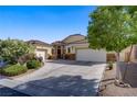 Well-maintained home featuring three-car garage, landscaped front yard and beautiful architectural details at 8125 Turbys Treehouse Pl, Las Vegas, NV 89131