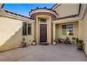 Charming home entrance with a decorative door, manicured plants, and a welcoming entryway at 8125 Turbys Treehouse Pl, Las Vegas, NV 89131