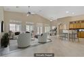 Staged living room with neutral tones, high ceilings, abundant natural light, and a seamless flow at 8125 Turbys Treehouse Pl, Las Vegas, NV 89131