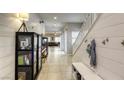 Inviting hallway featuring shiplap walls, neutral paint, and a staircase to the upper level at 8137 Crushed Velvet Pl, Las Vegas, NV 89166