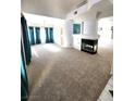Open living room with plush carpet, fireplace, and plenty of natural light at 8788 Elise Ct, Henderson, NV 89074