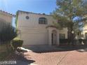 Inviting two-story home with a red tile roof, arched window, and well-maintained front yard at 8829 Cornwall Glen Ave, Las Vegas, NV 89129