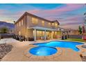 Gorgeous backyard featuring a large pool, jacuzzi, and covered patio, perfect for entertaining at 885 Violet Hill St, Las Vegas, NV 89110