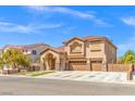 Charming two-story house with a three-car garage, manicured lawn, and inviting entryway at 885 Violet Hill St, Las Vegas, NV 89110
