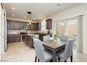 Bright kitchen with stainless steel appliances, tile backsplash, and adjacent dining area with backyard access at 8929 Sleepy Panda Ave, Las Vegas, NV 89148
