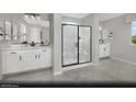 Bright bathroom featuring double vanity, walk-in glass shower, and modern fixtures at 9674 Biedler Ct # Lot 10, Las Vegas, NV 89178