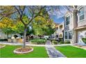 Charming courtyard featuring lush landscaping, outdoor seating, and a built-in grilling area at 10001 Peace Way # 1341, Las Vegas, NV 89147