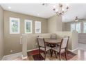 Cozy dining area with wood table, seating for four, and a decorative chandelier at 10191 Deerfield Beach Ave # 202, Las Vegas, NV 89129