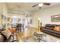 Open-concept living room and dining area with hardwood floors, natural light, and comfortable seating at 10553 Pine Pointe Ave # 203, Las Vegas, NV 89144