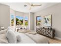 Bright bedroom with golf course views, a ceiling fan, and stylish furnishings at 10557 Shoalhaven Dr, Las Vegas, NV 89134