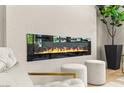 Contemporary electric fireplace on a textured wall with modern furniture and decor at 10557 Shoalhaven Dr, Las Vegas, NV 89134