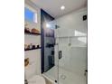 Clean bathroom features a glass shower, sleek fixtures, and neutral color scheme with floating shelves at 10709 Hunters Woods Pl, Las Vegas, NV 89134