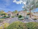Charming single-story home with desert landscaping, a decorative fence, and mature shade trees at 10709 Hunters Woods Pl, Las Vegas, NV 89134