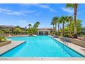 Resort-style pool with palm trees and lounge areas for relaxing and enjoying the sun at 10809 Garden Mist Dr # 1004, Las Vegas, NV 89135