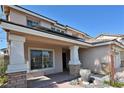 Inviting front porch with brick accents and neutral stucco for a warm welcome at 1105 Enderly Ln, Las Vegas, NV 89144