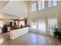 Bright living room with tall windows, tile floors, and neutral decor, creating a cozy atmosphere at 1105 Enderly Ln, Las Vegas, NV 89144