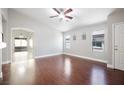 A bright room with dark wood floors and ample natural light, ready for personalization at 11079 Zampino St, Las Vegas, NV 89141