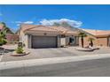 A well-maintained single-story home featuring a two-car garage and desert landscaping at 2305 Hot Oak Ridge St, Las Vegas, NV 89134