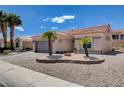 A charming single-story home features desert landscaping, a two-car garage, and a welcoming entrance at 2305 Hot Oak Ridge St, Las Vegas, NV 89134