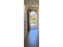 Bright entryway with tile flooring and an open view to the front yard through the open arched doorway at 2321 Teatro Ave, Henderson, NV 89044
