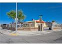Street corner view of a well-maintained single-story home behind a decorative concrete block and wrought iron fence at 2832 Geist Cir, Las Vegas, NV 89115