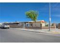 Cozy single-story home featuring a decorative concrete block and wrought iron fence on a sunny day at 2832 Geist Cir, Las Vegas, NV 89115