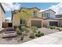 Inviting two-story home with desert landscaping, brick driveway, and walkway at 2877 Sweeping Palm Rd, North Las Vegas, NV 89086