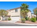 A two-story home displaying the garage, landscaping, and a corner view at 3314 Villa Fiori Ave, Las Vegas, NV 89141