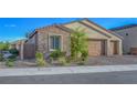 Beautiful single-story home with stone accents, three-car garage, and a well-kept front yard at 3495 Luca Point Ave, Henderson, NV 89044