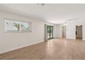 Open living area with wood tile flooring and access to the backyard through French doors at 4573 Plaza De Vista St, Las Vegas, NV 89120