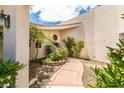 Inviting home entrance featuring a landscaped courtyard with a curved walkway leading to the front door at 4765 N Grand Canyon Dr, Las Vegas, NV 89129