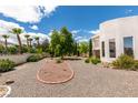 Expansive desert landscaped backyard featuring gravel, decorative rock, palm trees, and mature landscaping at 4765 N Grand Canyon Dr, Las Vegas, NV 89129
