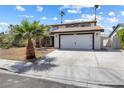 Well-maintained two-story home with an attached two-car garage and concrete driveway at 5035 Meadow Grove Ct, Las Vegas, NV 89120