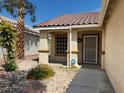 Inviting covered front porch with beige pillars and security screen door at 5512 Oakwood Ridge St, Las Vegas, NV 89130