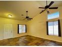 Spacious living room with tiled floors, a high ceiling, two ceiling fans, and lots of light at 5512 Oakwood Ridge St, Las Vegas, NV 89130