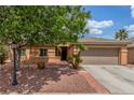Charming single-story home featuring a well-maintained yard, mature tree, and a two-car garage at 5588 La Sendas Ct, Las Vegas, NV 89122