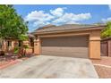 Single-story home featuring a well-maintained yard, mature tree, and a two-car garage at 5588 La Sendas Ct, Las Vegas, NV 89122