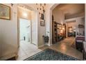 Hallway with archways leading to laundry room; neutral decor with tiled flooring at 5844 Gushing Spring Ave, Las Vegas, NV 89131