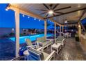 Charming covered patio overlooking a beautiful pool and outdoor area at 5852 Ireland Ridge Ct, Las Vegas, NV 89149