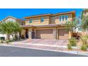 Charming exterior view of a two-story home with a large three-car garage and meticulously maintained landscaping at 600 Suncrest Peak Pl, Henderson, NV 89011