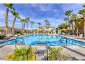 Stunning community pool with palm trees and lounge chairs, perfect for relaxation and enjoyment at 6255 W Arby Ave # 118, Las Vegas, NV 89118