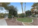 Manicured front yard with trimmed trees and bushes offers a peaceful approach to the home at 6733 W Charleston Blvd # 3, Las Vegas, NV 89146