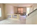 Spacious living room with tile flooring, natural light, and staircase to the second level at 6778 Goose Watch Ct, Las Vegas, NV 89139
