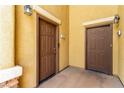 Close-up of two brown front doors, highlighting private entrances and building architecture at 6868 Sky Pointe Dr # 1122, Las Vegas, NV 89131