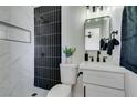 Stylish bathroom with white marble tile, a modern black shower, and updated fixtures at 709 Rossmoyne Ave, North Las Vegas, NV 89030