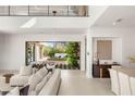 Modern living room with seamless indoor-outdoor flow, stylish furniture, and view to the landscaped backyard at 7385 Heron Canyon Ct, Las Vegas, NV 89117
