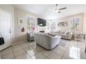 Bright living room features tile floors, a fireplace, and ample natural light from multiple windows at 7704 Himalayas Ave # 204, Las Vegas, NV 89128