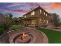 Spacious backyard with a built-in fire pit, covered patio, and lush artificial turf at 7761 Boyd Ave, Las Vegas, NV 89179