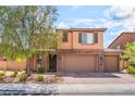 Charming two-story home with desert landscaping, brown exterior, and convenient three-car garage at 7761 Boyd Ave, Las Vegas, NV 89179
